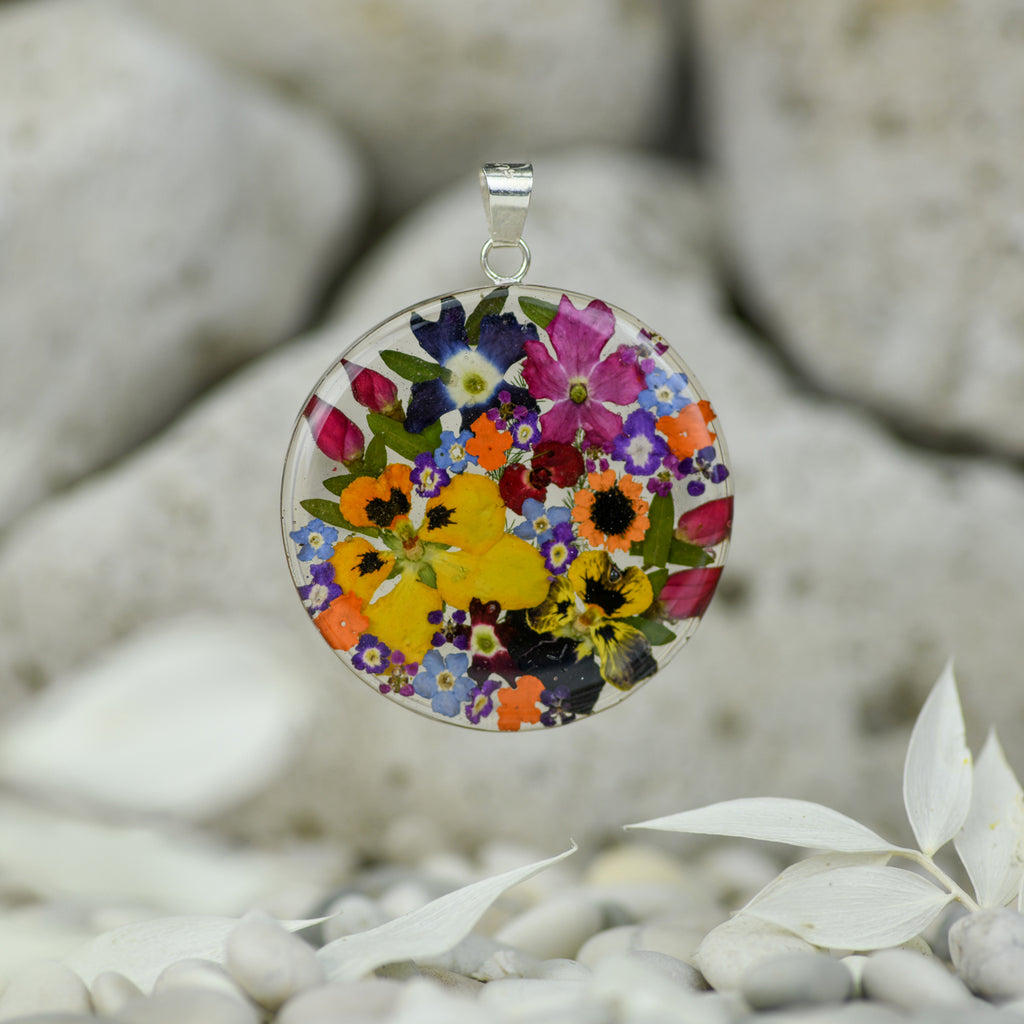 san marco large round shaped silver and resin pendant with various coloured dried flowers encased in the resin