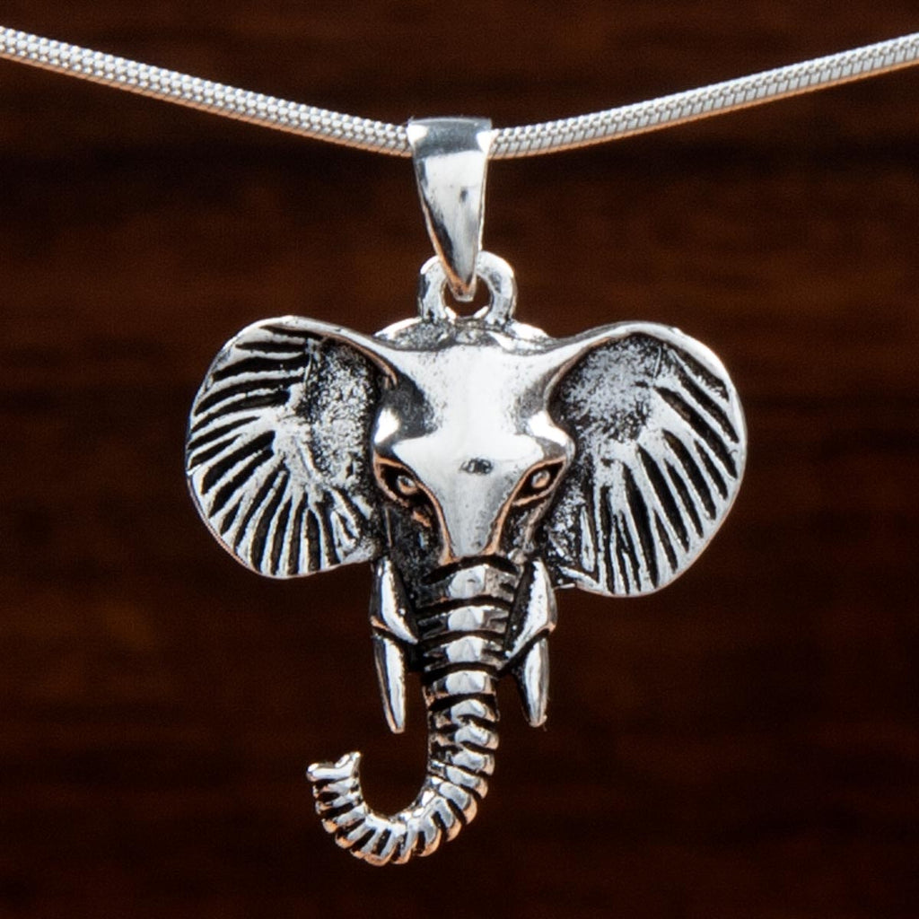 intricately detailed sterling silver pendant in the shape of a tusked elephant's head