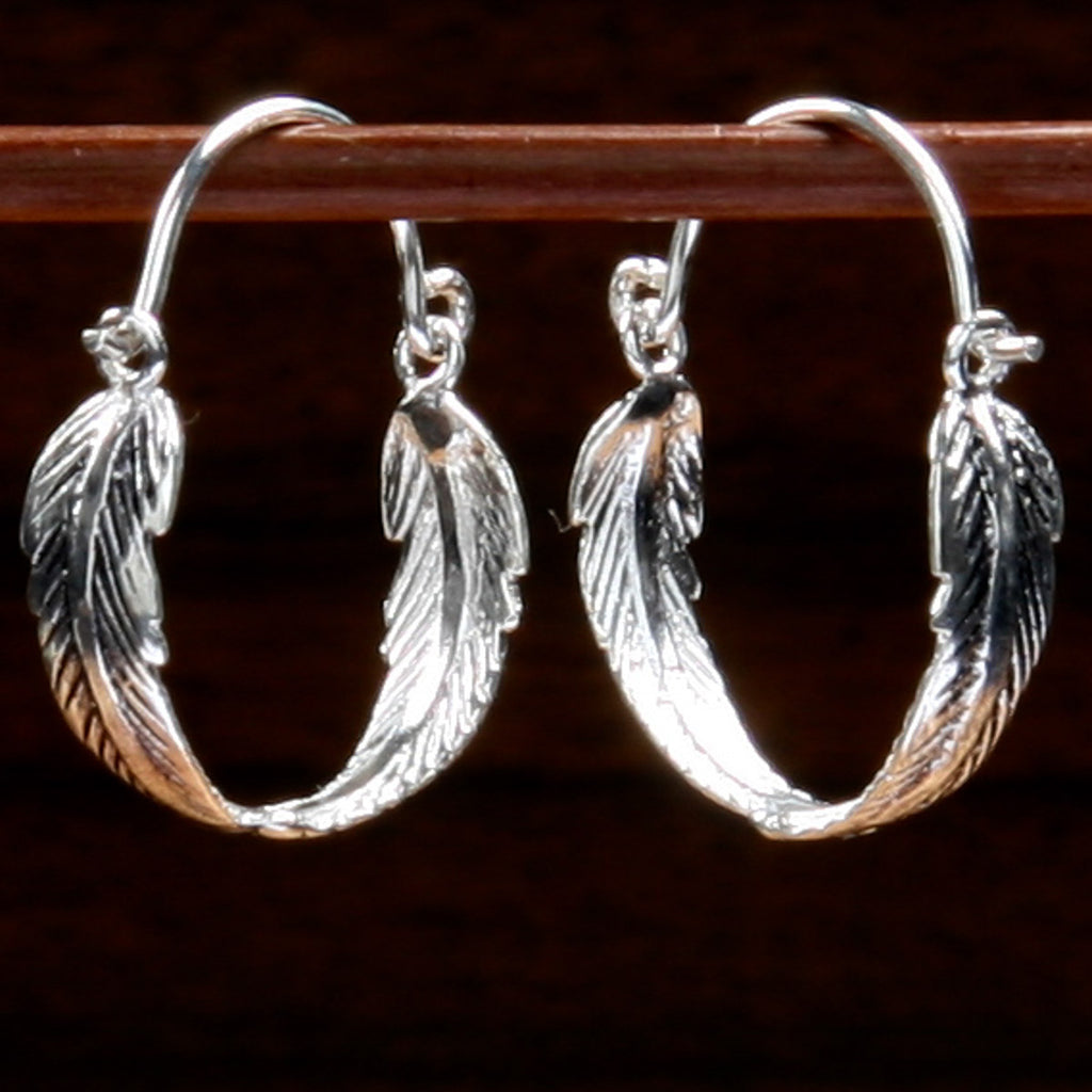 sterling silver earrings with a curved twin feather hoop design