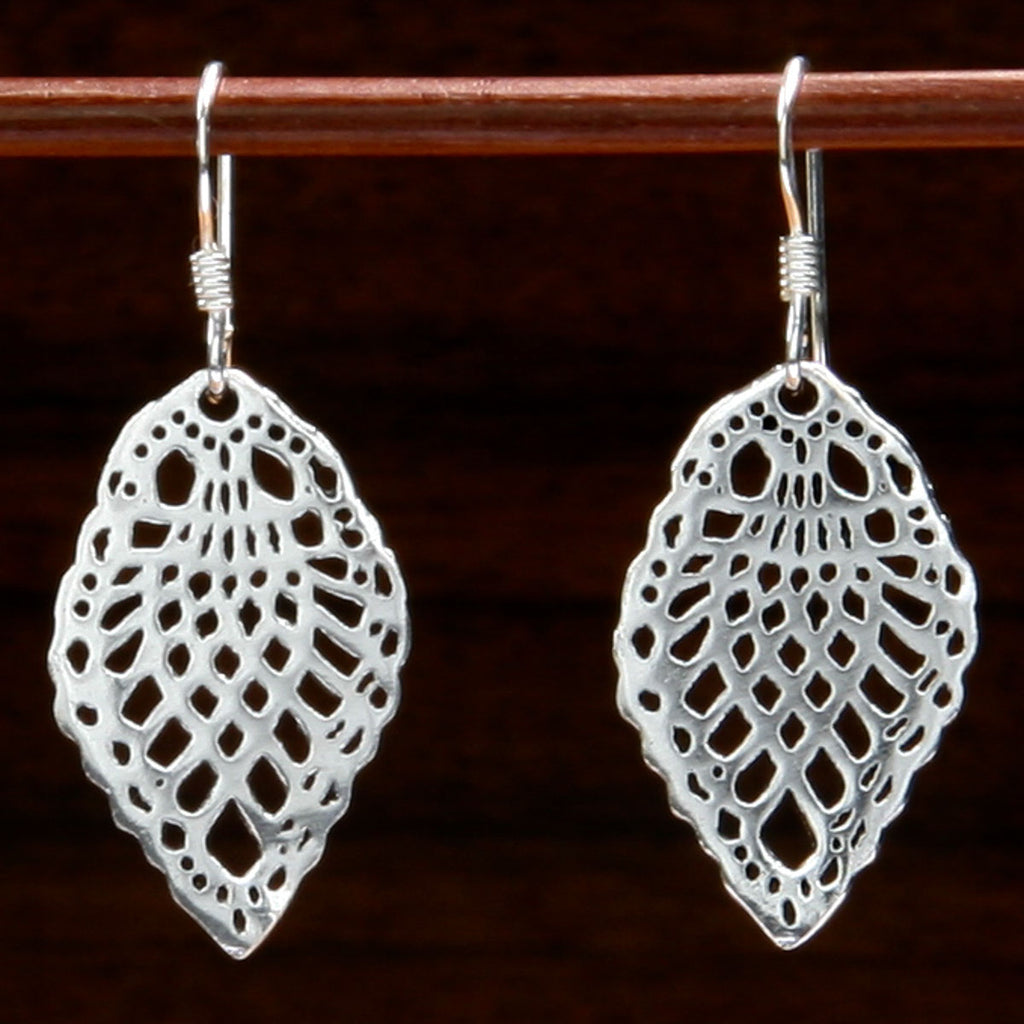 Two silver earrings decorated with nature and leaf motif