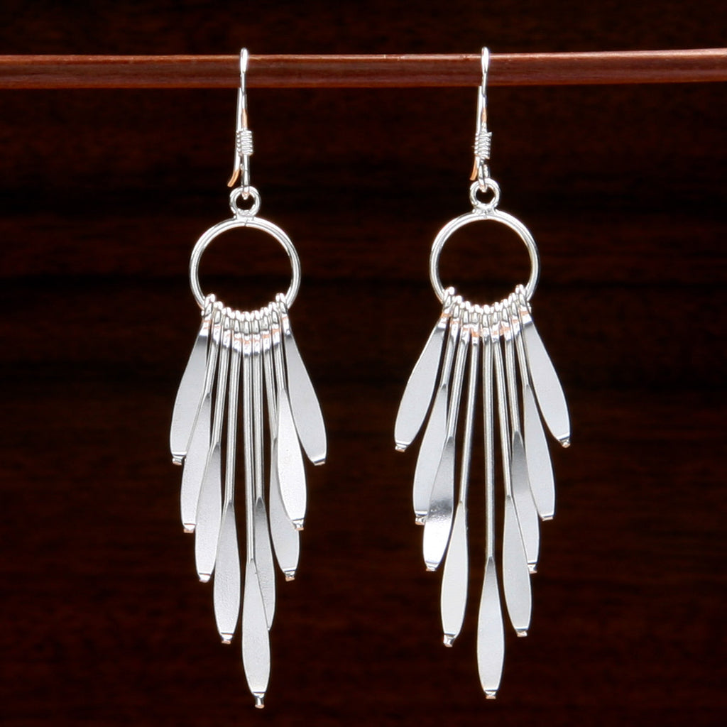 sterling silver shimmer earrings with nine pendulous blades of various length hanging in a v shape from a ring on each earring