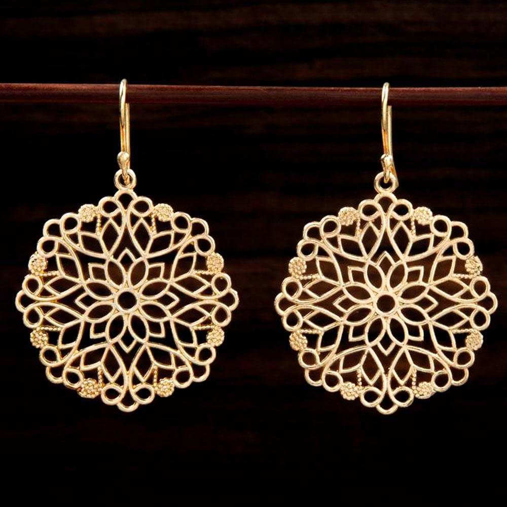 brass earrings with intricate snowflake-like design